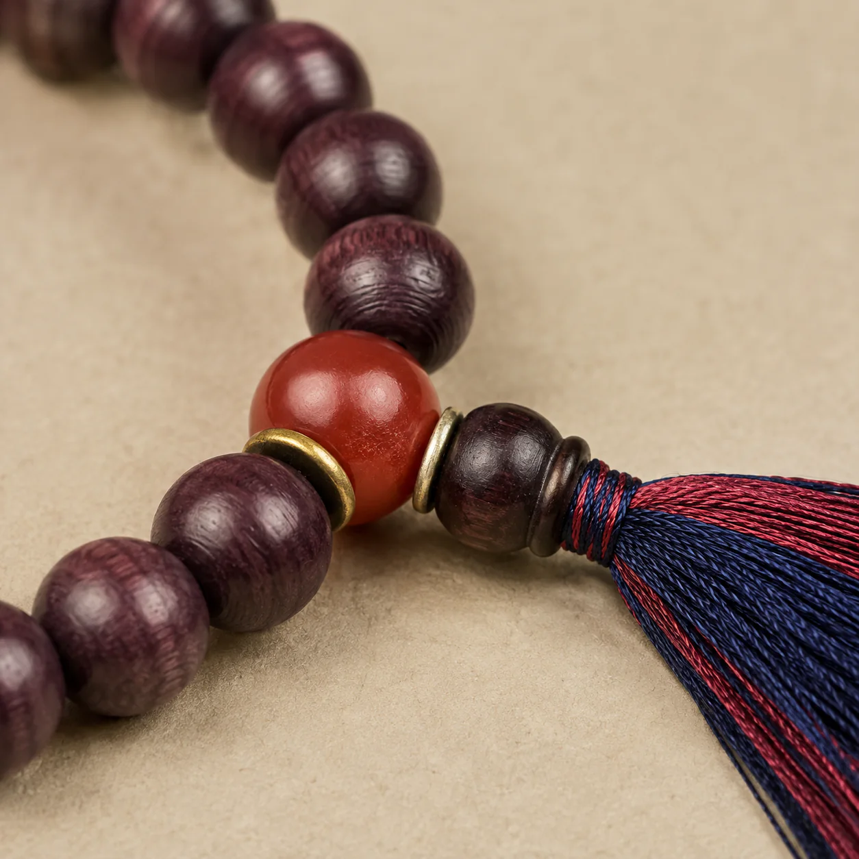 Plum wood bead bracelet tassel and material detail