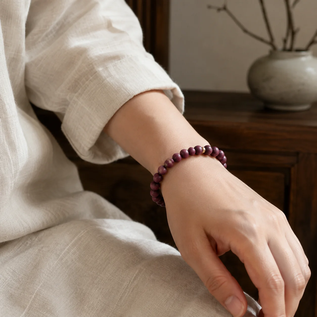 Plum wood bead bracelet worn with linen