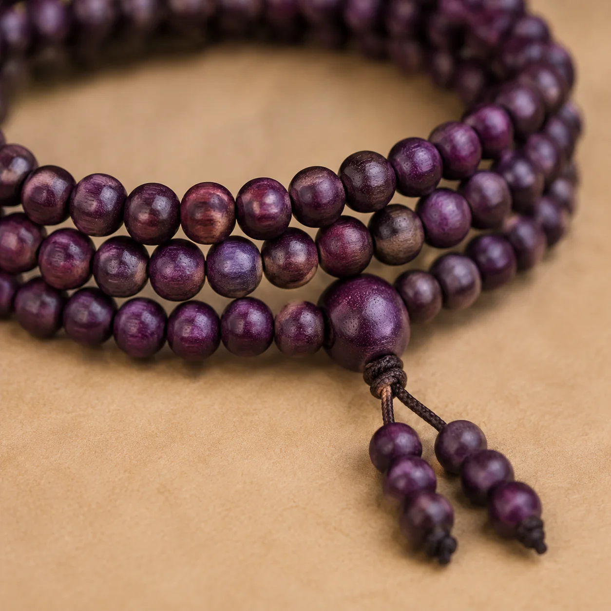 Plum wood multi-wrap bracelet tassel detail