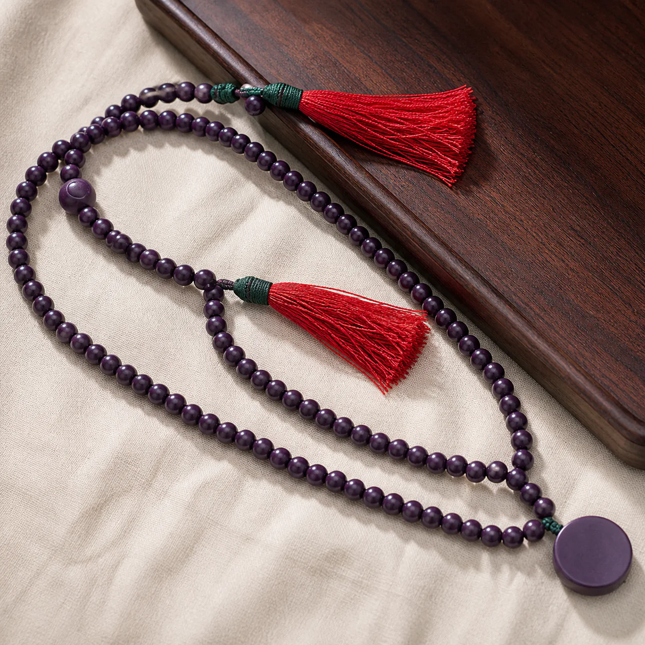 Purple wood bead mala in a refined setting