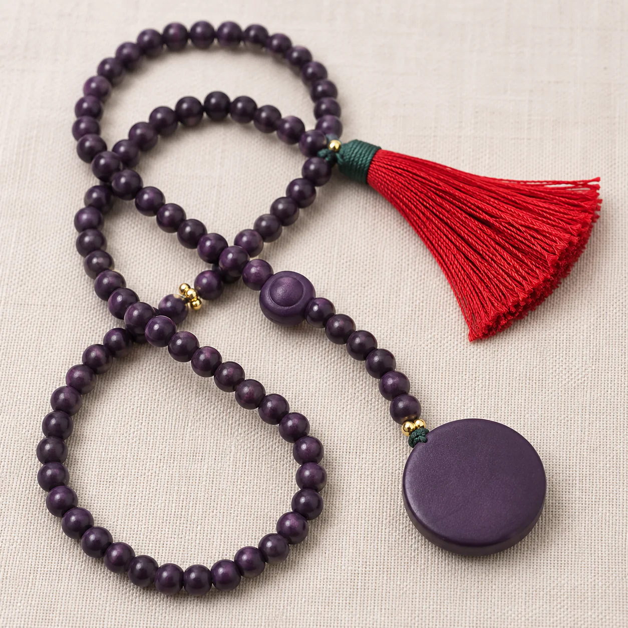 Purple wood bead mala tassel detail