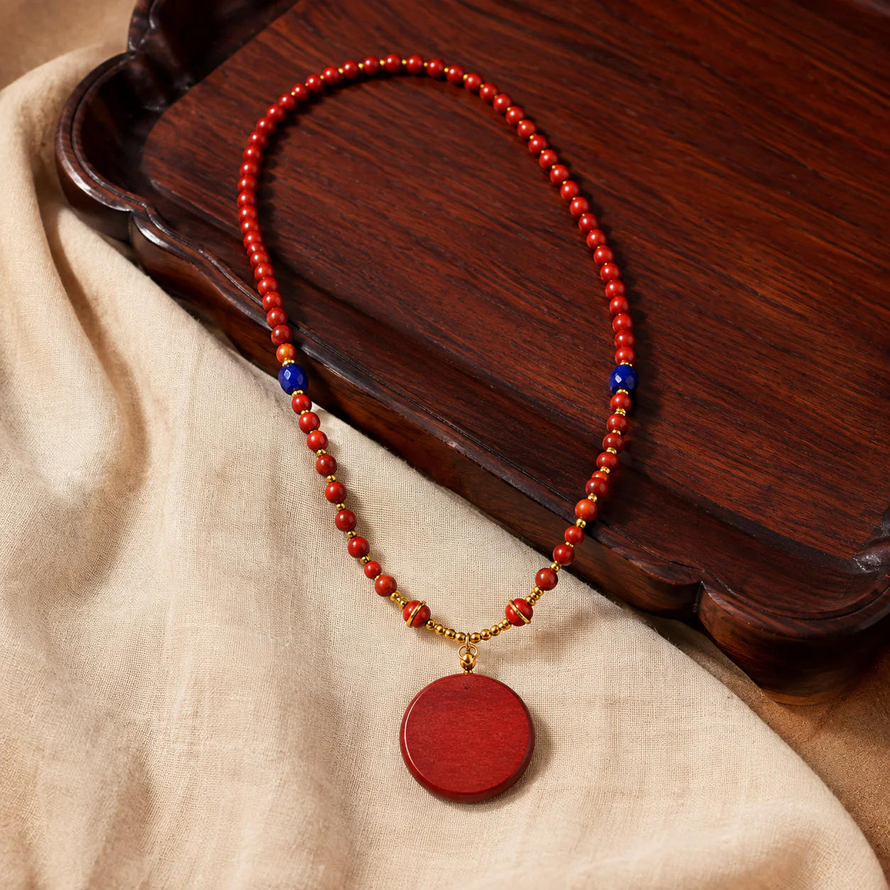 Red wood bead pendant necklace in a refined setting