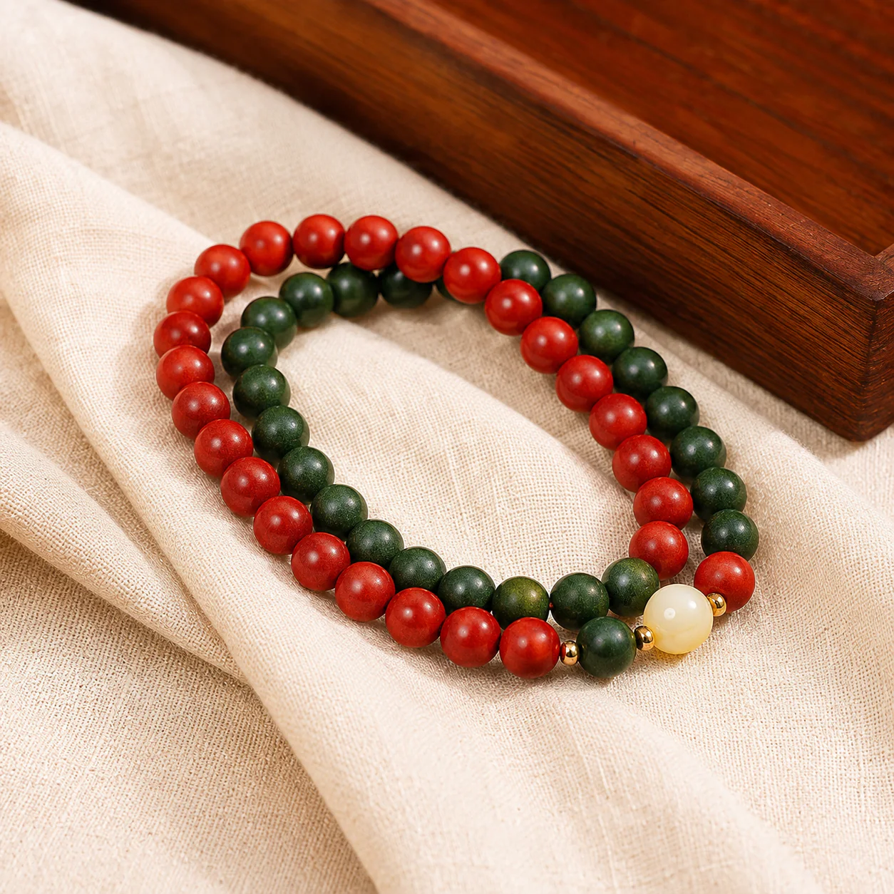 Red and green wood bead bracelet in a refined setting