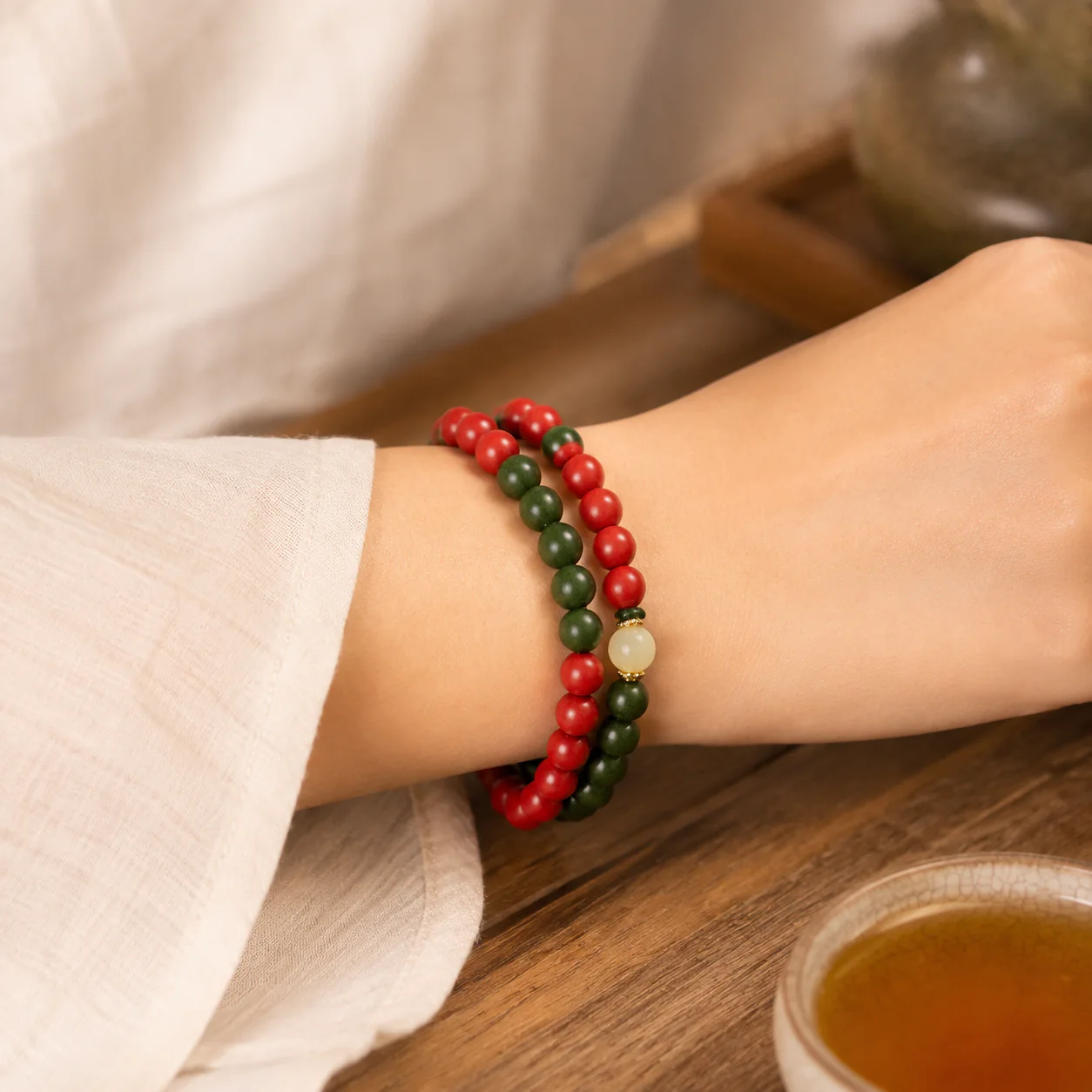 Red and green wood bead bracelet worn with linen