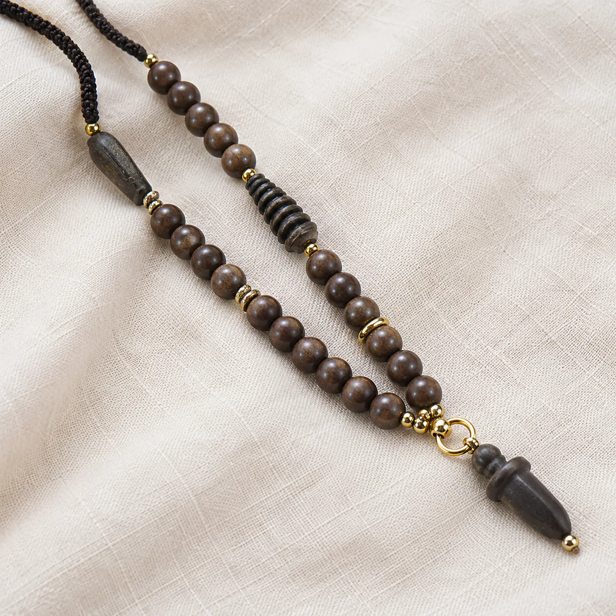 Dark wood bead pendant necklace material detail