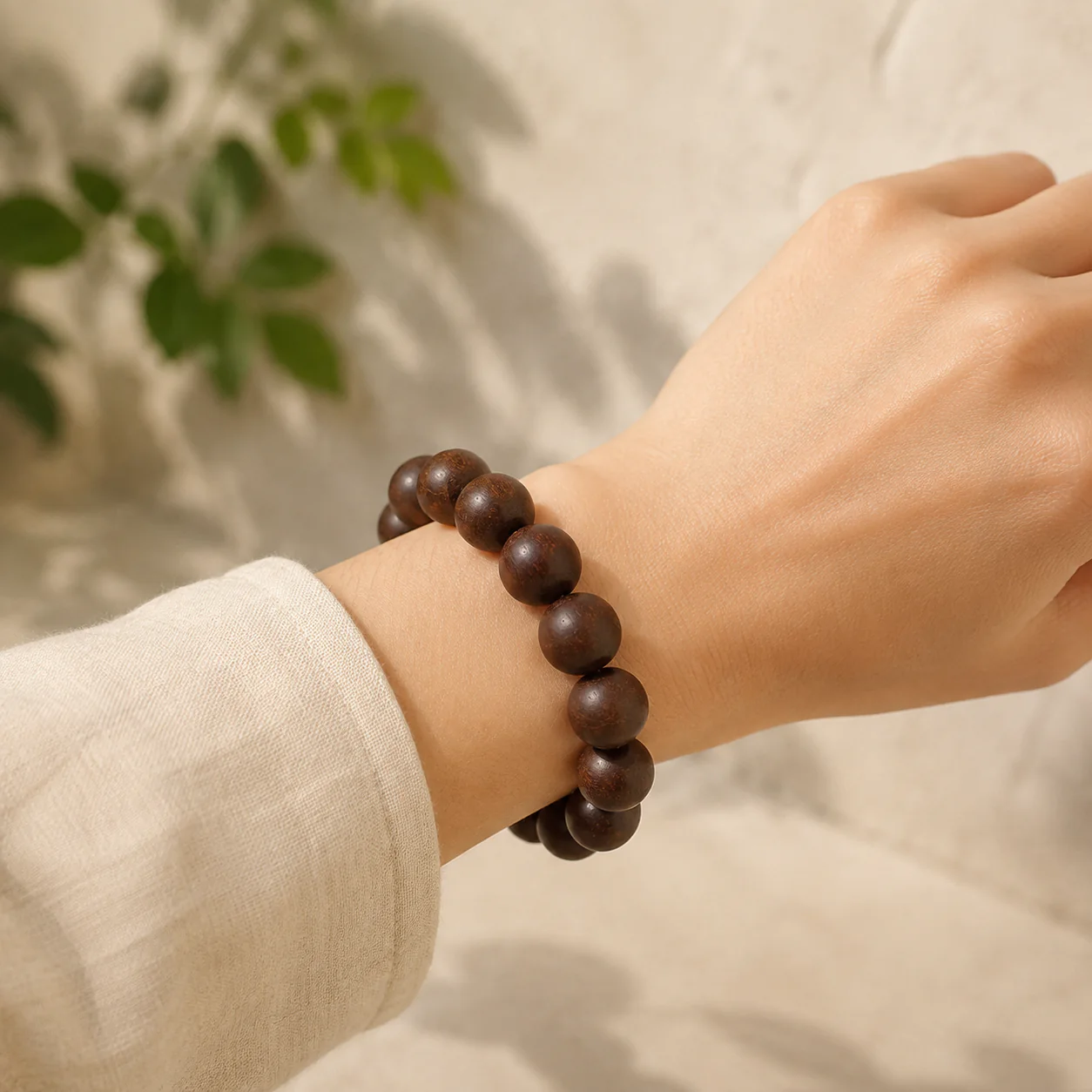 Dark wood bead bracelet worn with linen