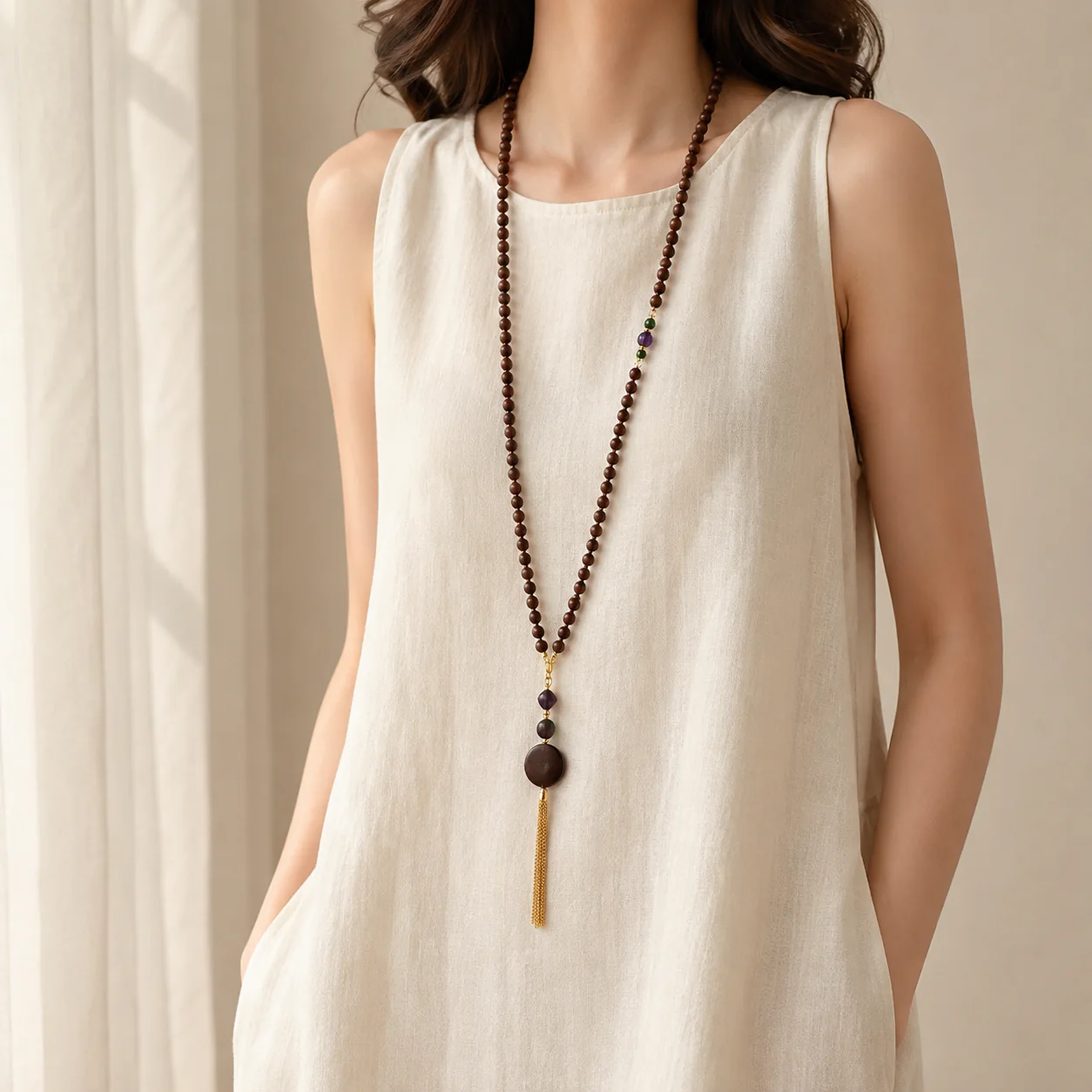 Long dark wood bead necklace worn with linen