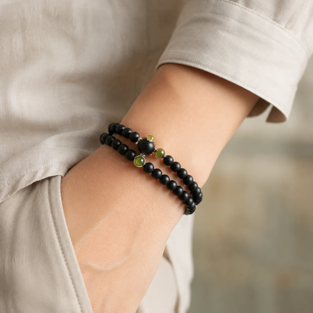 Dark wood double-wrap bead bracelet worn with linen