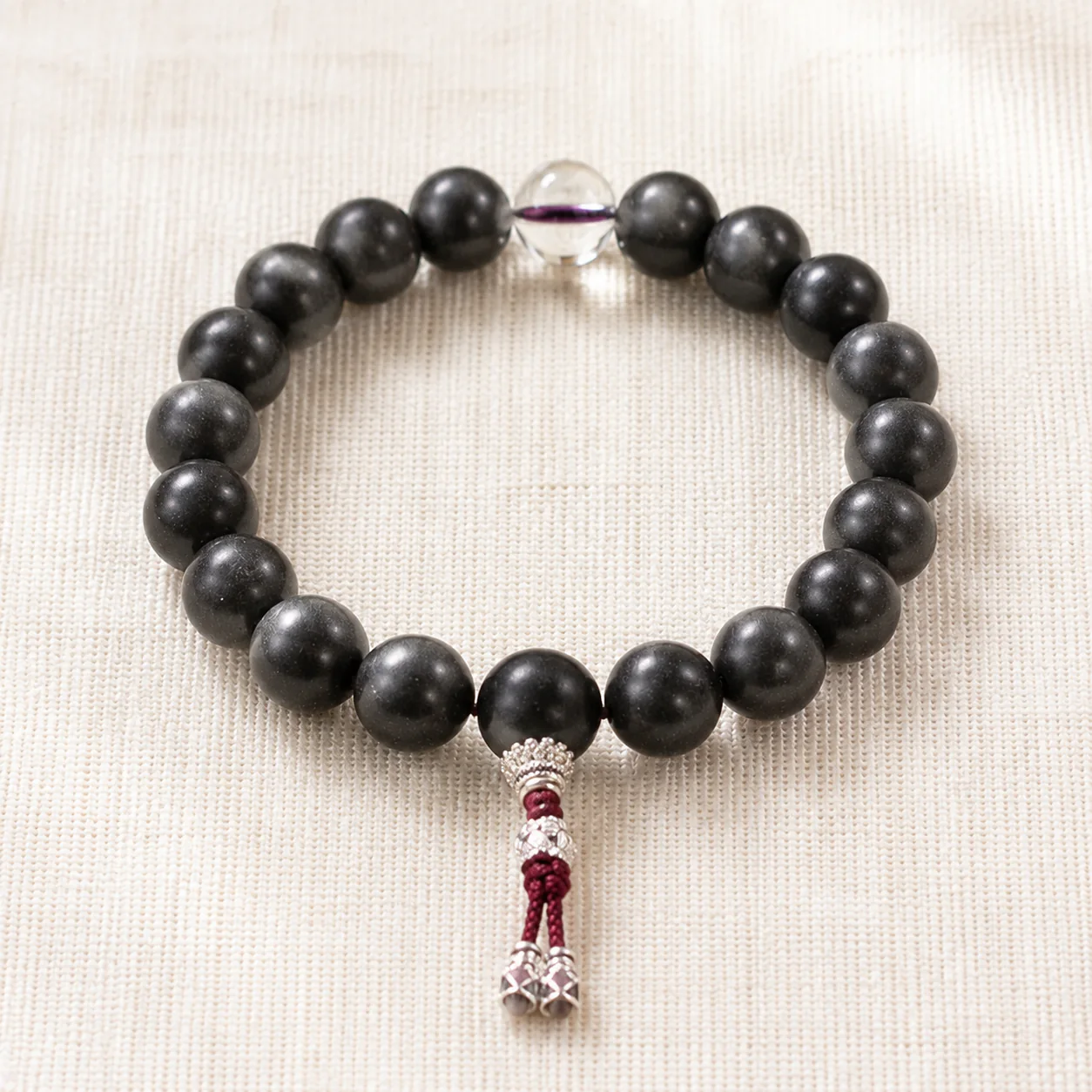 Dark wood bead bracelet with tassel full strand detail