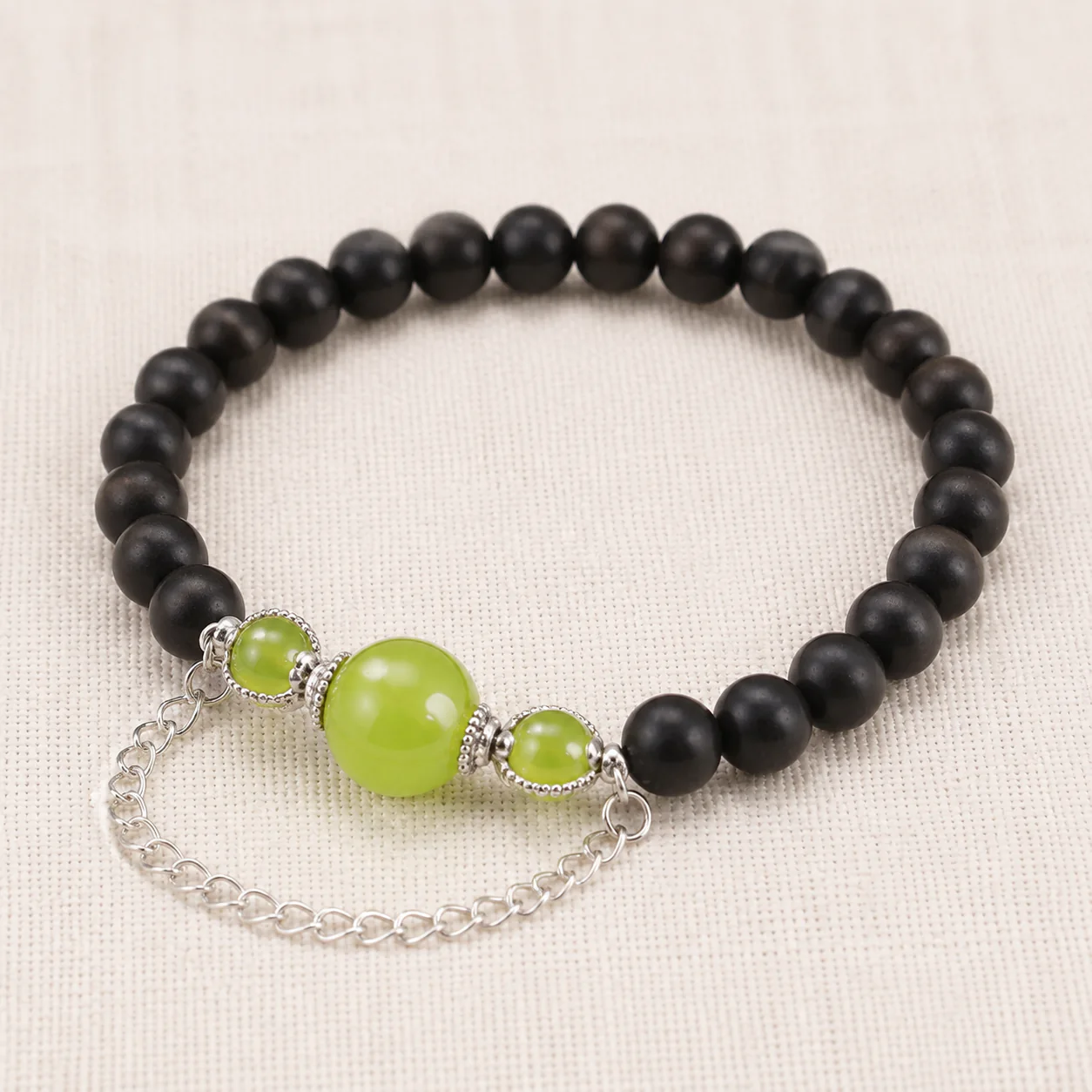 Dark wood bead bracelet with green stone full strand detail