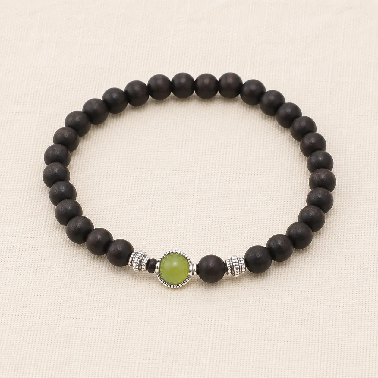 Dark wood bead bracelet with green gemstone full strand detail