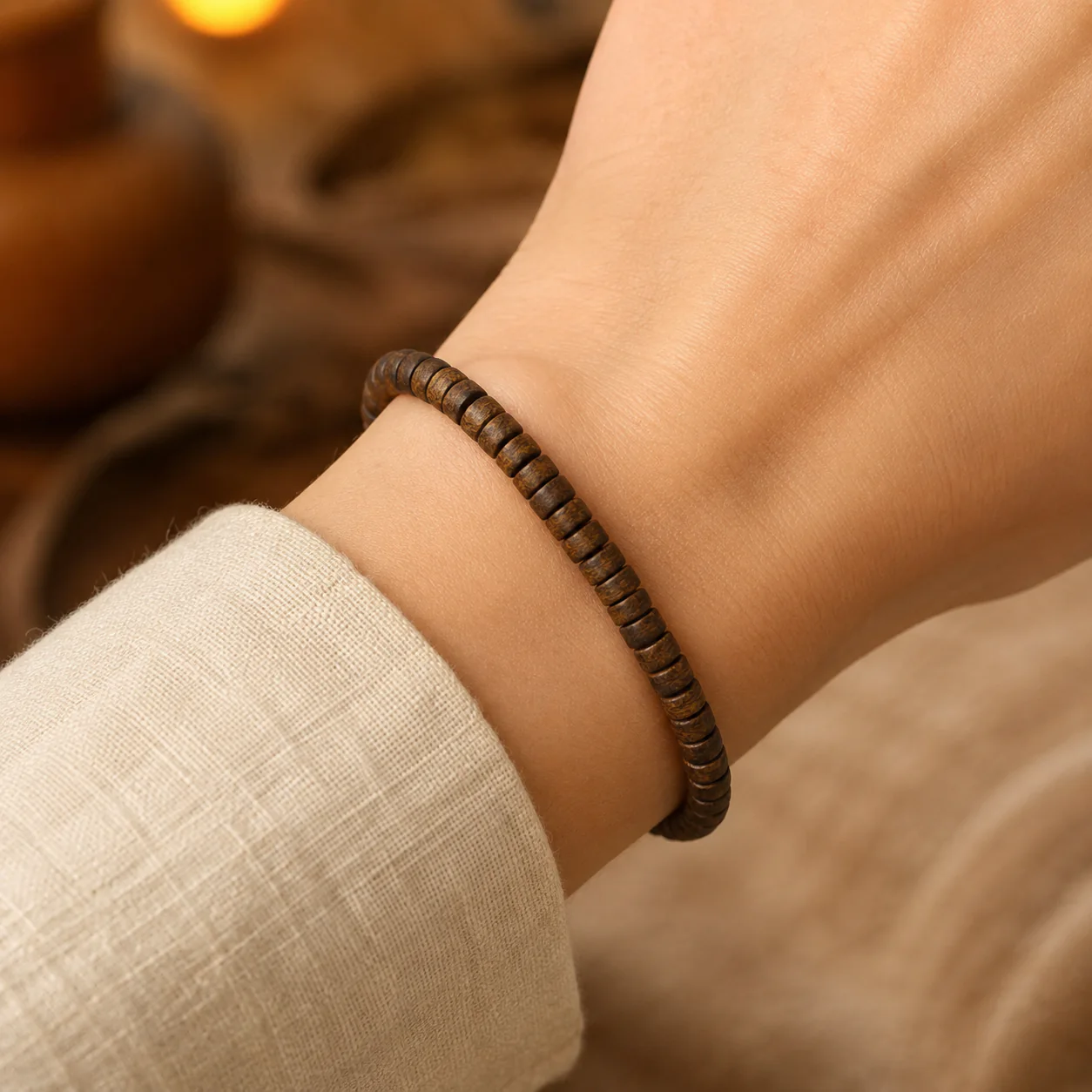 Agarwood disc-bead bracelet worn with linen