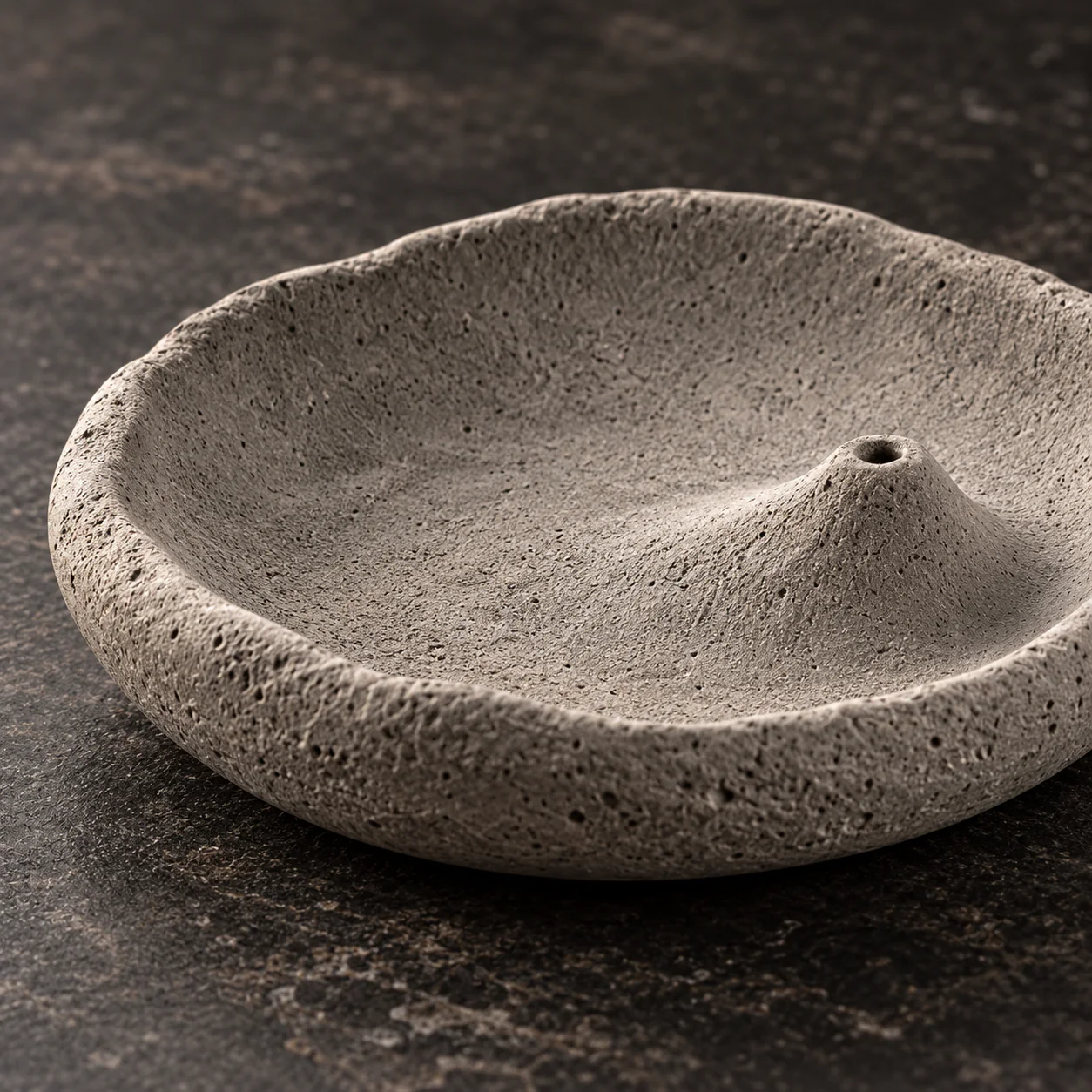 Close detail of the porous cement texture and incense hole