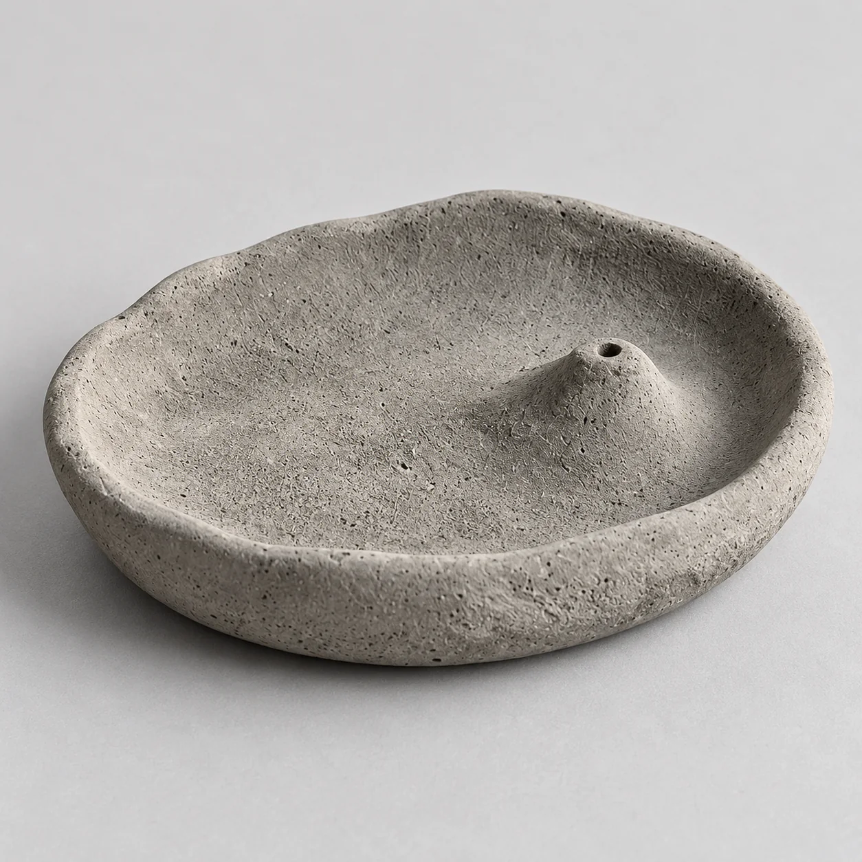 Top angled detail of the handmade gray cement incense tray