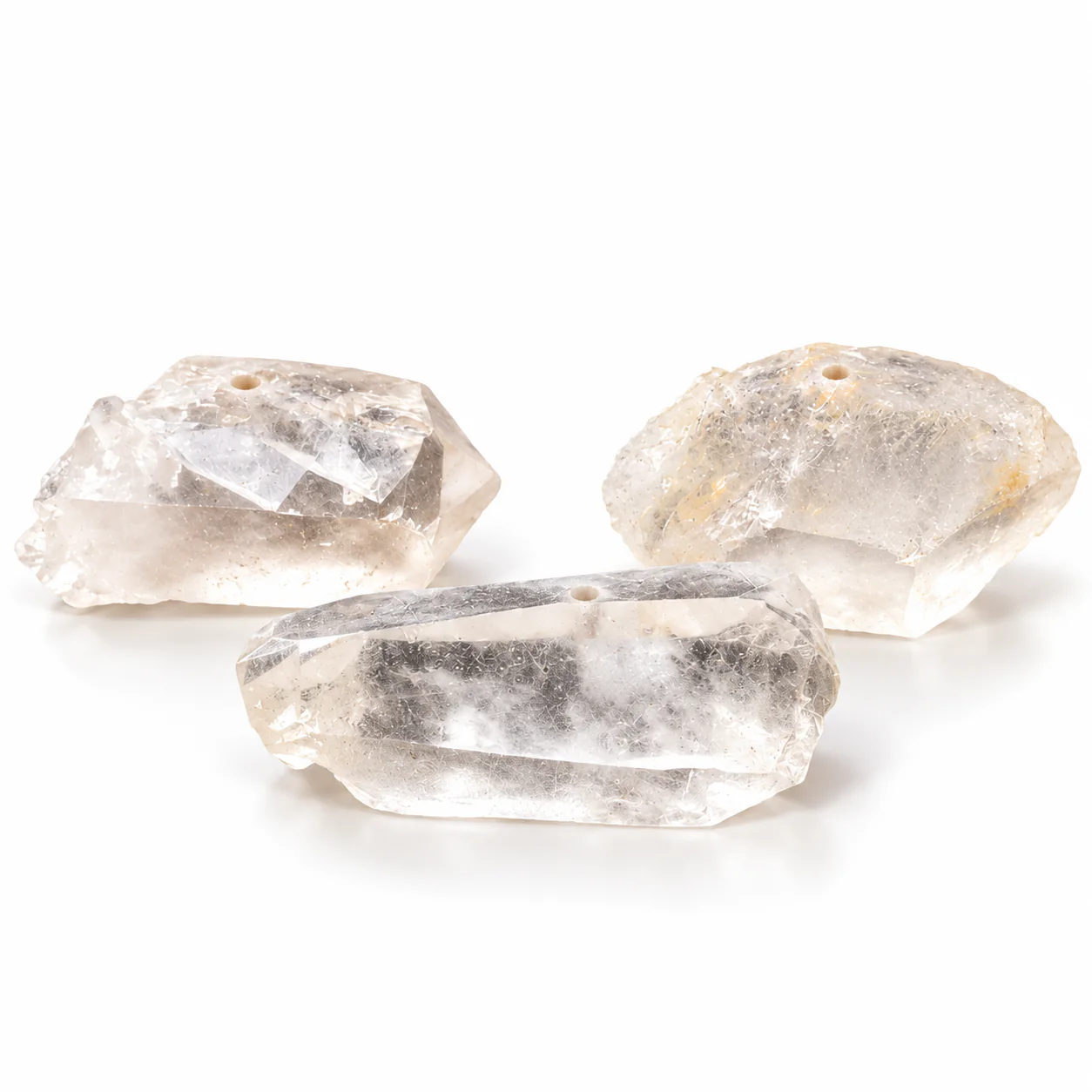 Three natural white crystal incense holders on a white background