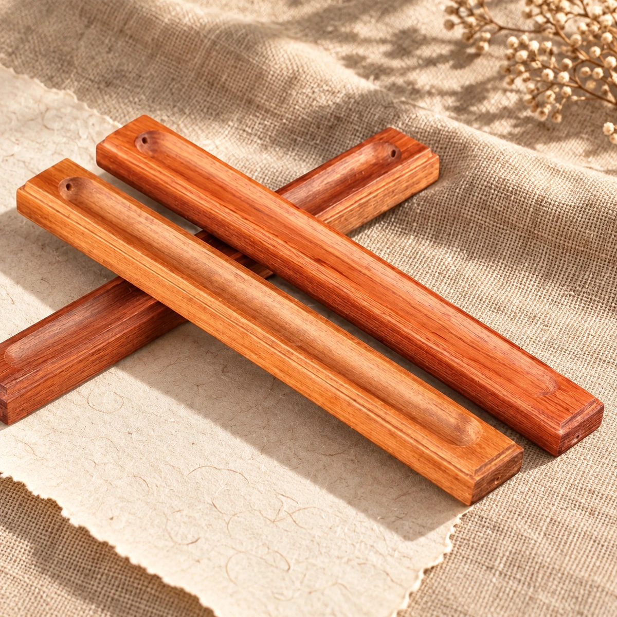 Slim wooden stick incense holders showing carved channels