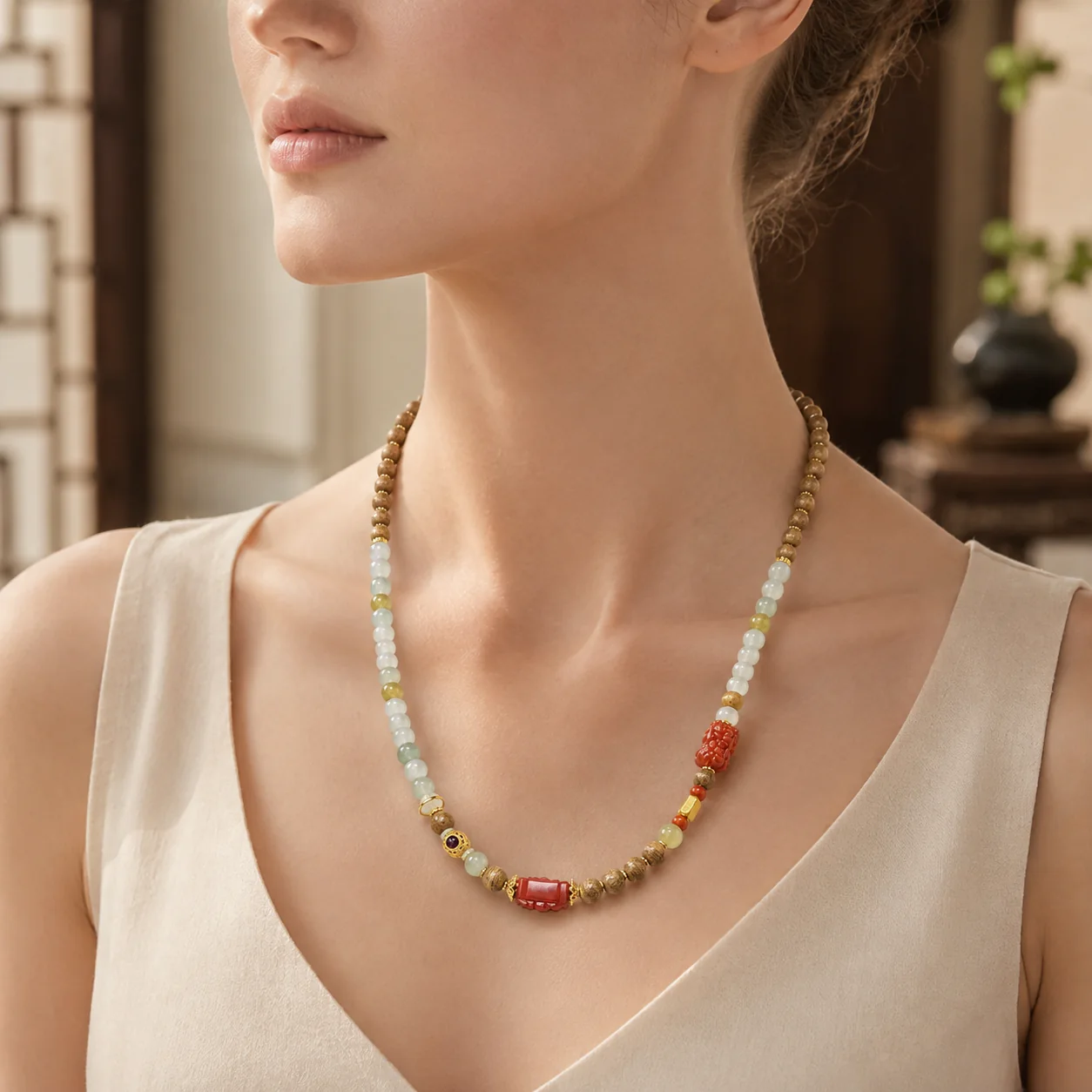Agarwood and pale jade bead necklace worn elegantly