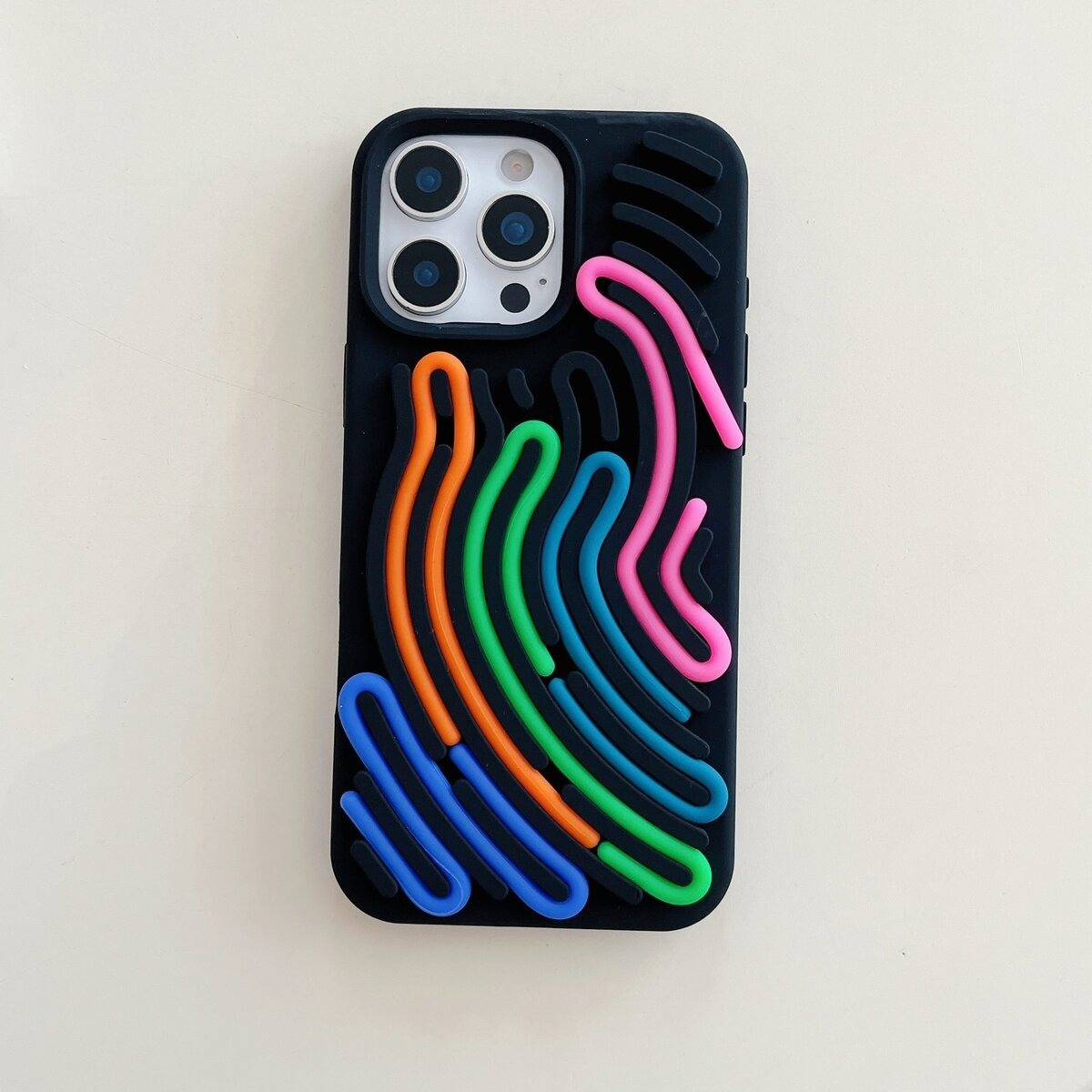 Black iPhone case close-up, neon rainbow wave pattern, protective phone cover