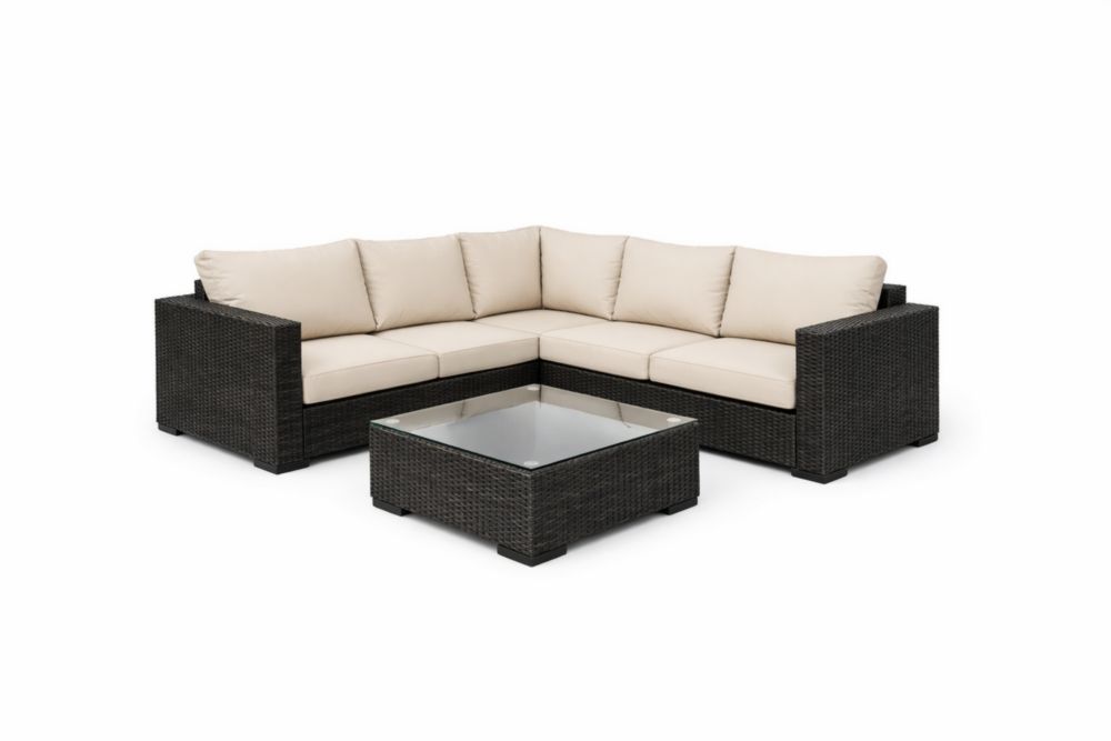 Set salotto angolare in rattan sintetico nero con cuscini crema e tavolino in vetro
