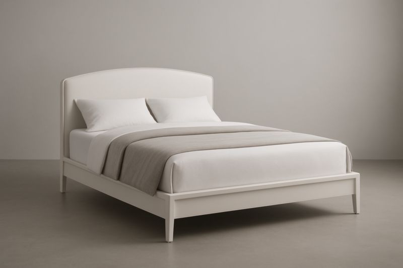 Lit en bois blanc avec matelas et oreillers