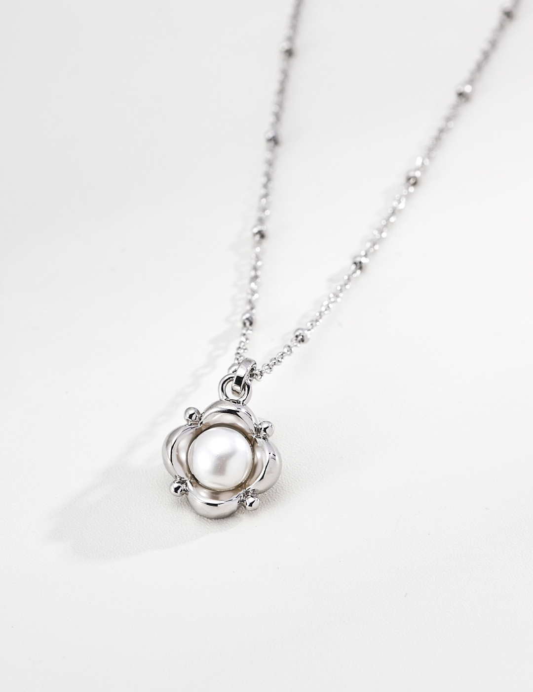 Pearls are the subtle gleam hidden near the ears, and silver jewelry cradles this gentle beauty.