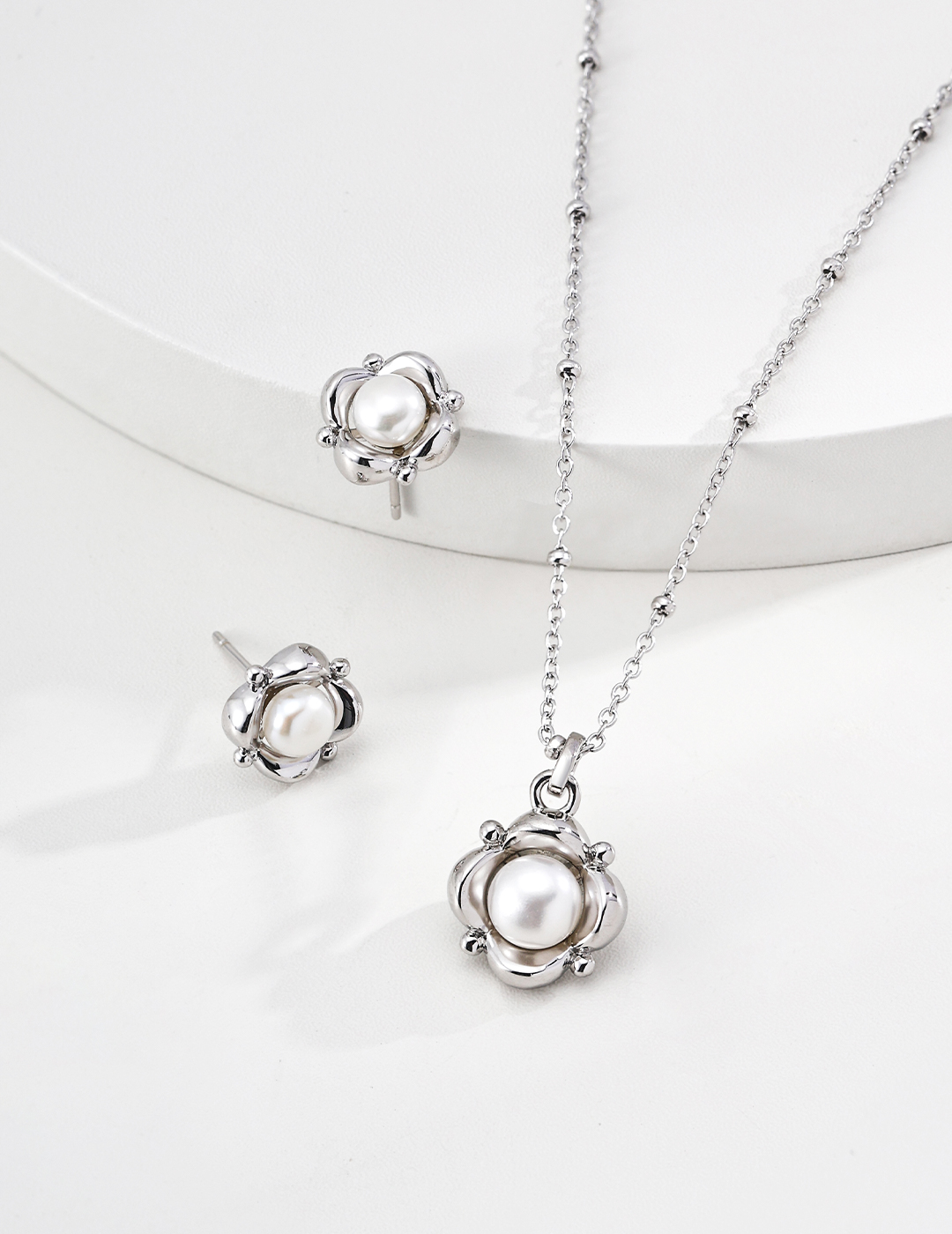 Pearls are the subtle gleam hidden near the ears, and silver jewelry cradles this gentle beauty.