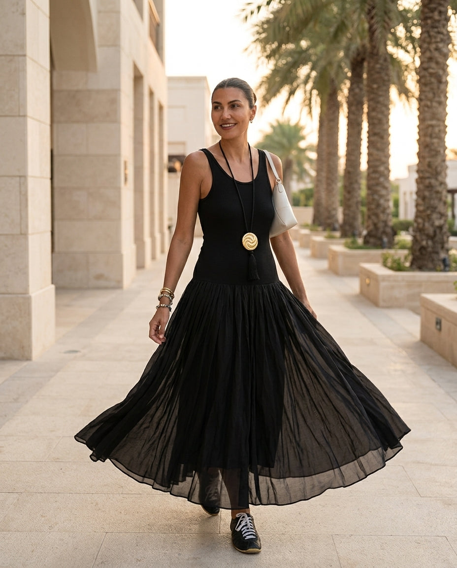 Black Charm Summer Textured Maxi Dress Black Maxi Dress with Relaxed Fit silhouette and Ribbed Knit texture, lifestyle scene image for Garden Party, an estate dinner at golden hour, US East / Hamptons Elite by Mesadic