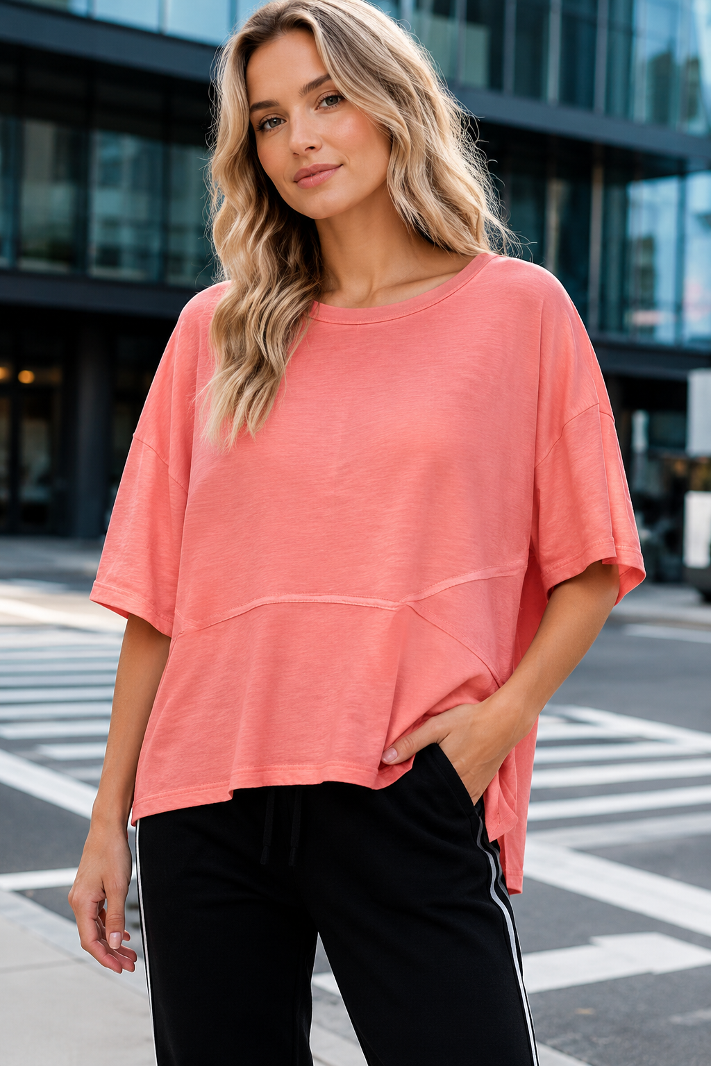 Women's top featuring a clean round neck, soft cotton-blend fabric, and slightly flared three-quarter sleeves.