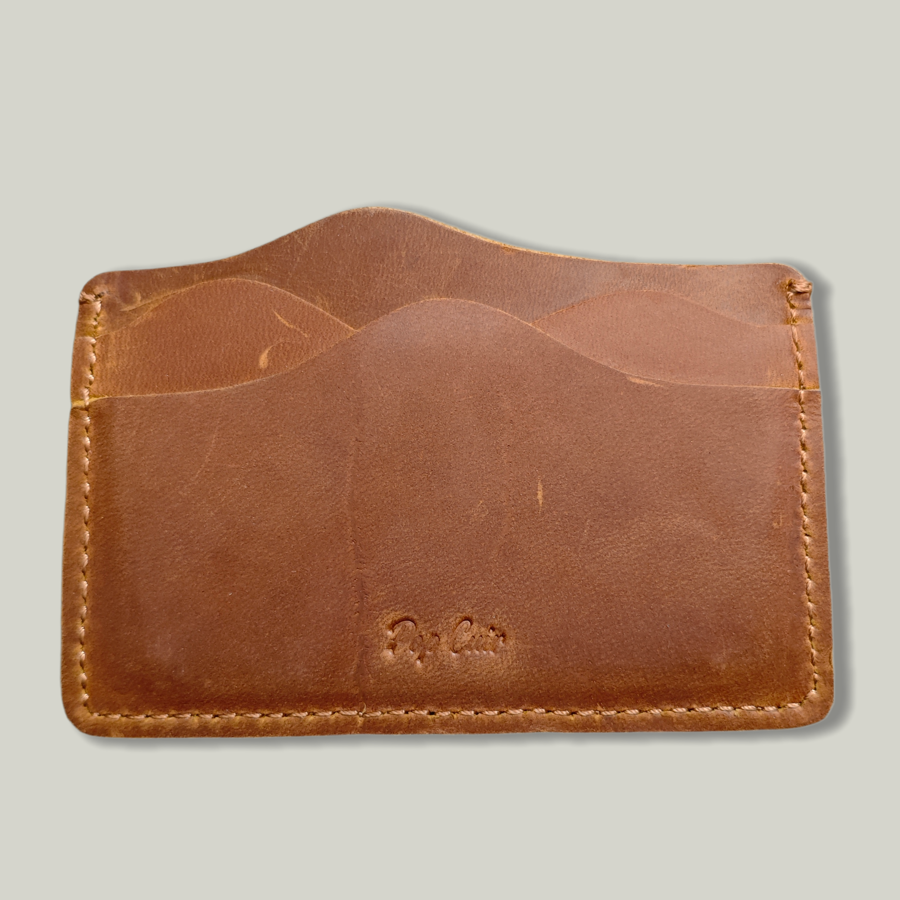 Handmade crazy horse leather 5-slot card holder in tan, with saddle-stitched edges, Pop Cuir logo embossed, slim minimalist wallet showing patina-ready surface