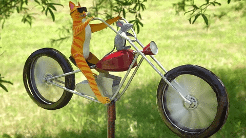 Cat and Rat motorcycle wind spinner spinning in the garden