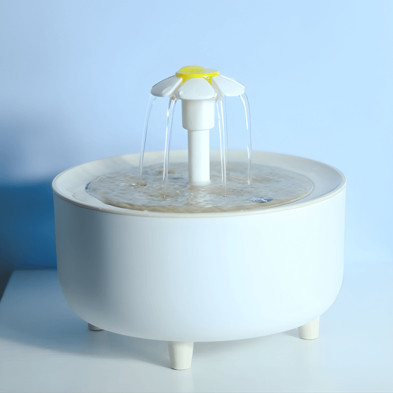 White pet water fountain on a light blue background