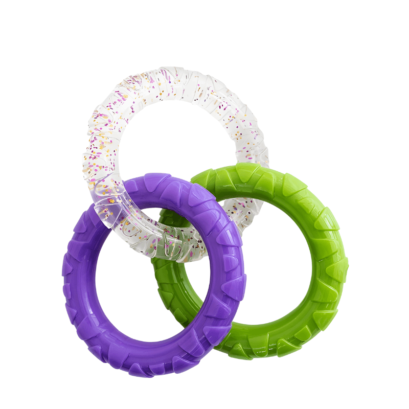 Three colorful rubber rings in purple, green, and clear with sprinkles on a white background