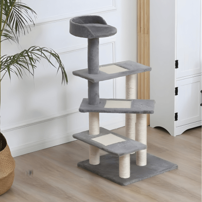 Gray cat tree with multiple levels and a plant in the background