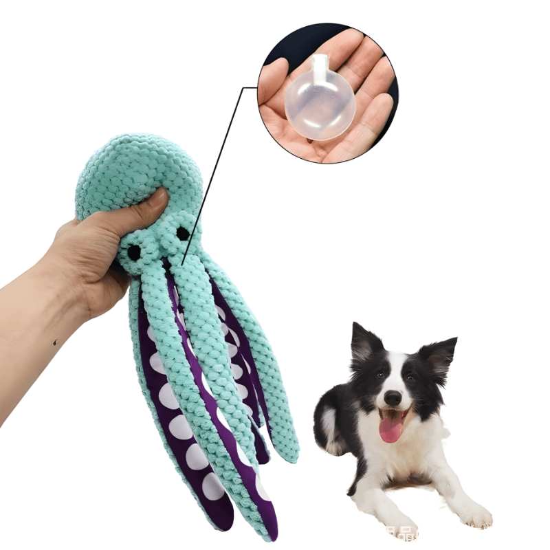 Teal octopus-shaped dog toy held by a hand with a close-up of a small white ball, and a dog lying on the floor.
