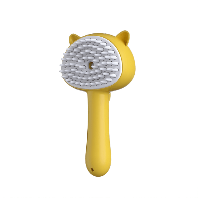 Yellow pet grooming brush with a white bristle head on a white background