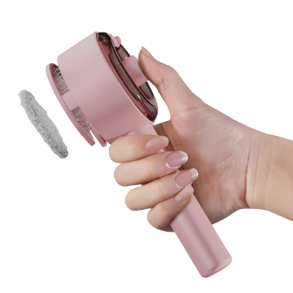 Pink handheld cleaning brush with a gray bristle head held by a hand on a white background