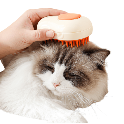 Person using a pet grooming brush on a cat's head with a white background