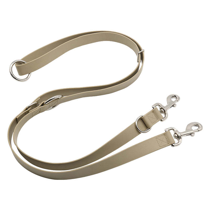 Beige bag strap with silver hardware on a white background