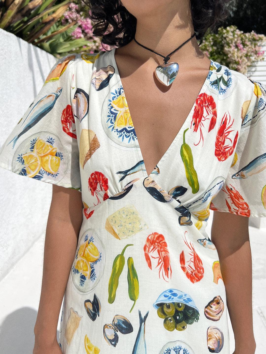 Puffy 3D Heart Necklace featuring a clean chic design and modern nature gold/silver and black braided rope ,perfect for dailylife/party/office/casual occasion. Displayed in a cool mood setting with a model wearing a v neck dress.