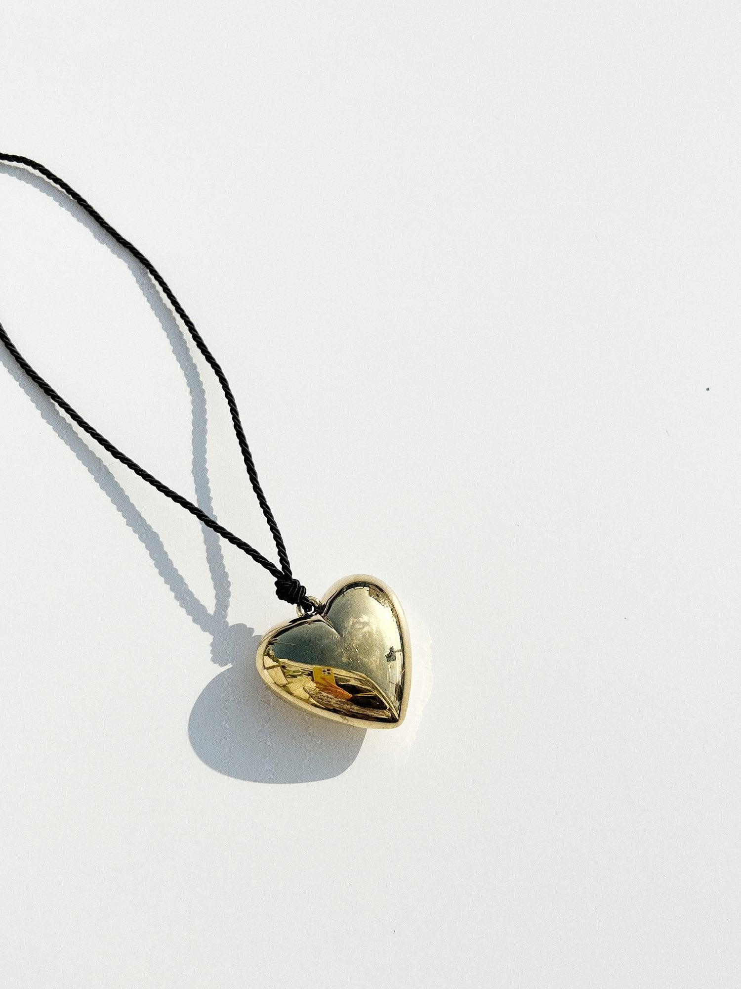 Puffy 3D Heart Necklace featuring a clean chic design and modern nature gold and black color ,perfect for dailylife/party/office/casual occasion. Styled against a white background.
