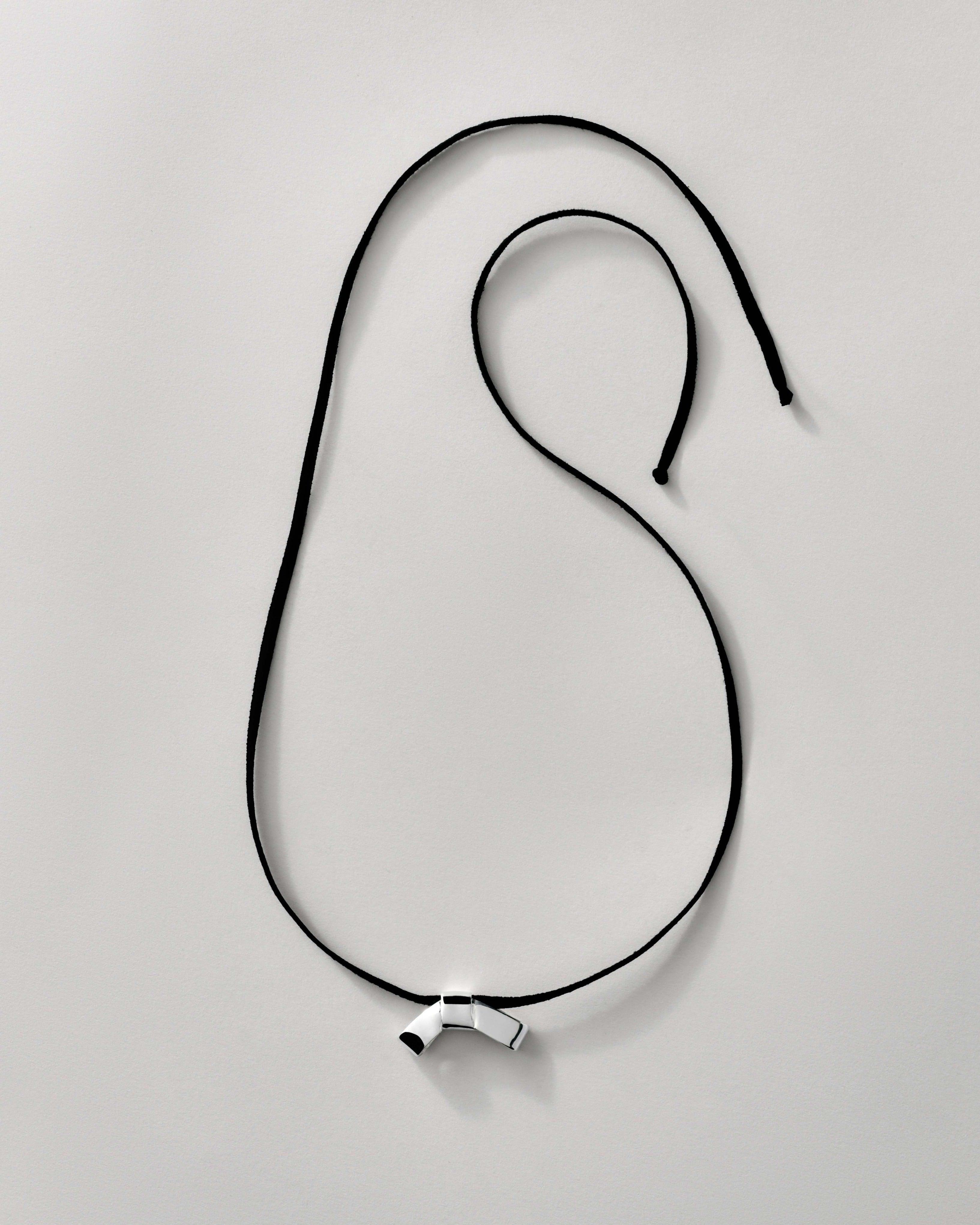 PETITE BOW FAUX SUEDE RIBBON CRAVAT NECKLACE featuring a clean chic design and modern sharp silver and black color ,perfect for dailylife/party/office/casual occasion. Styled against a white background.
