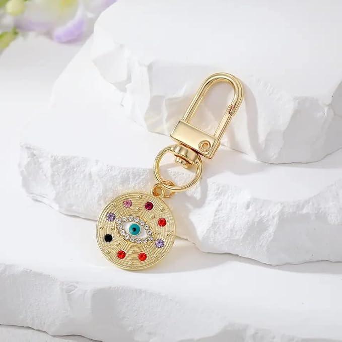 Silver Gold Evil Eye Keychain for Women Protection Good Luck Charms Key Chain for Car Keys Holder Bag Purse featuring a clean chic eye design and gold and multi color ,perfect for daily /party/casual/office bagcharm/chain charm decoration . Styled against a white stone background.