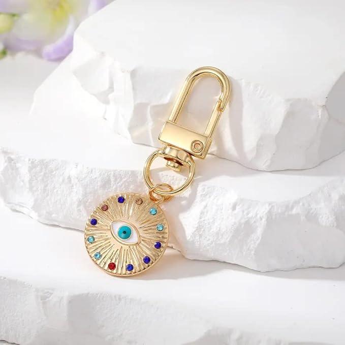 Silver Gold Evil Eye Keychain for Women Protection Good Luck Charms Key Chain for Car Keys Holder Bag Purse featuring a clean chic eye design and gold and multi color ,perfect for daily /party/casual/office bagcharm/chain charm decoration . Styled against a white stone background.