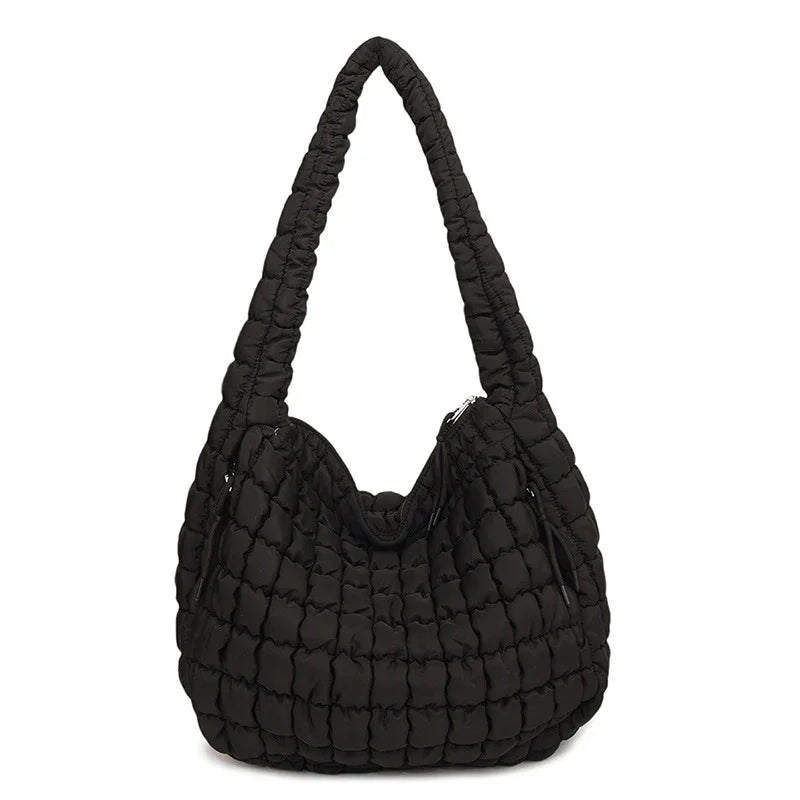 Black quilted handbag on a white background freepeople coupon  sale code skirt puffer bag dress white crop top girl cute clothing mindfully outfits cottagecore  cotton good quality comfy chic vacation daily White quilted handbag on a white background