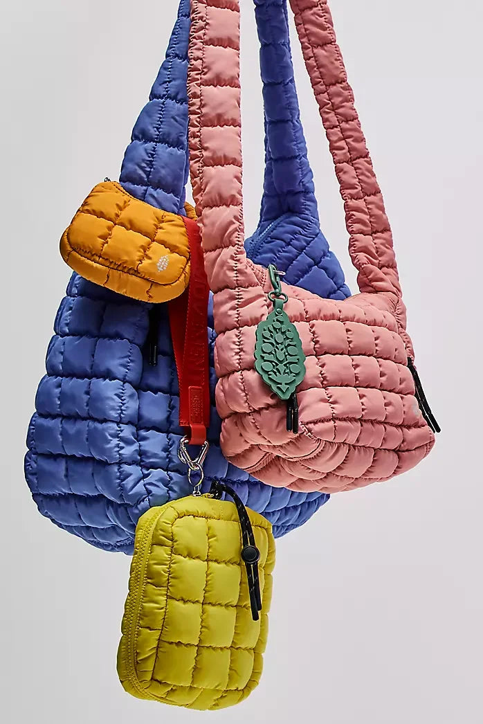 Colorful quilted handbags with leaf designs on a light gray background freepeople coupon  sale code skirt puffer bag dress white crop top girl cute clothing mindfully outfits cottagecore  cotton good quality comfy chic vacation daily White quilted handbag on a white background