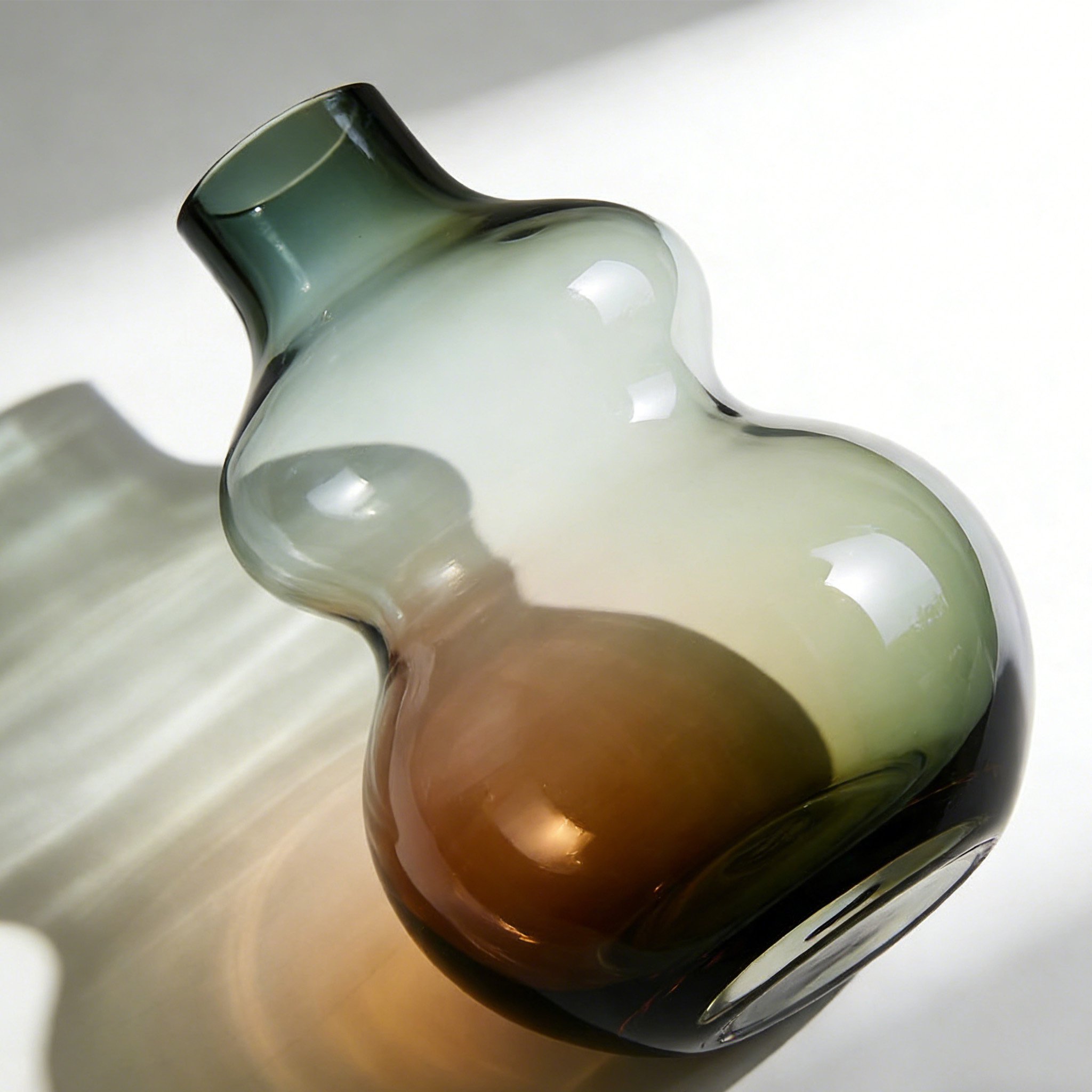 Gradient color glass vase on a wooden table