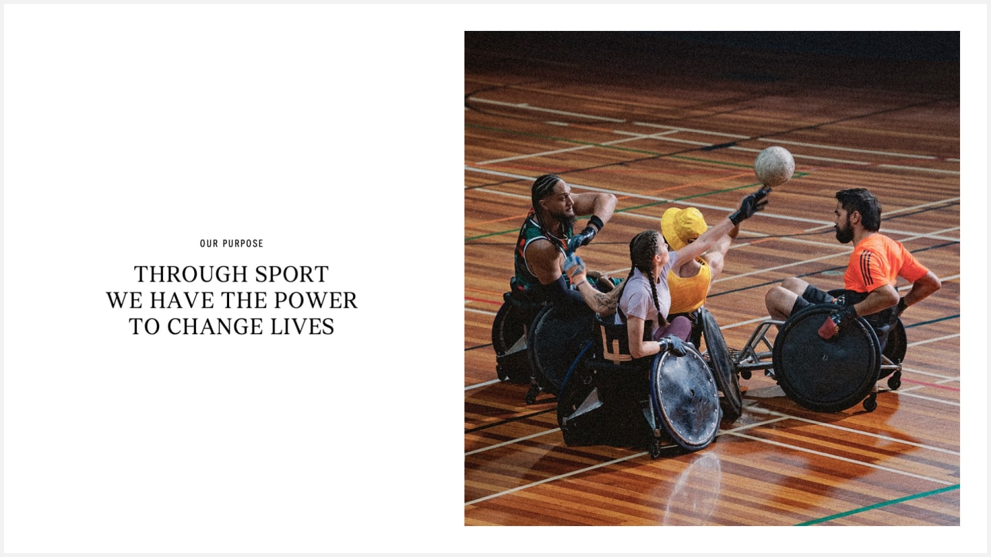 Wheelchair rugby players compete energetically on a wooden court. A ball is in the air, indicating intense play. Text reads: "Through sport, we have the power to change lives."