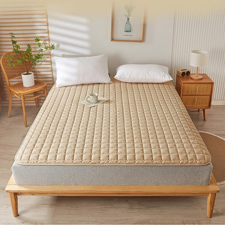 Soft anti-slip mattress cushion on a bed