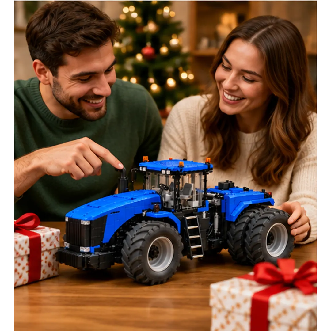 Two adults enjoying a blue tractor brick model together beside wrapped holiday gifts