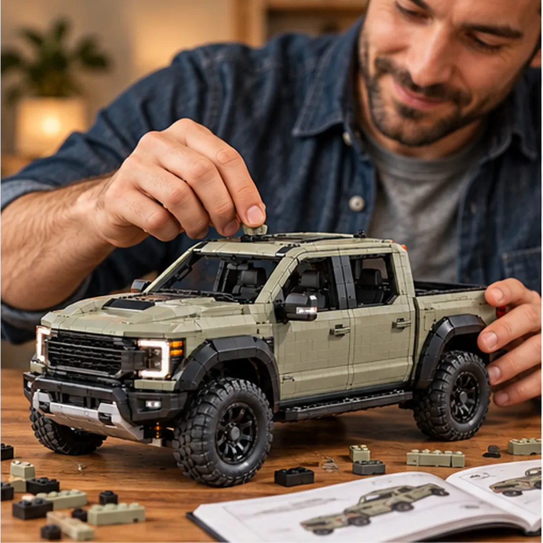 Adult builder fitting a small brick onto the roof of the pickup with loose pieces and an illustrated guide nearby